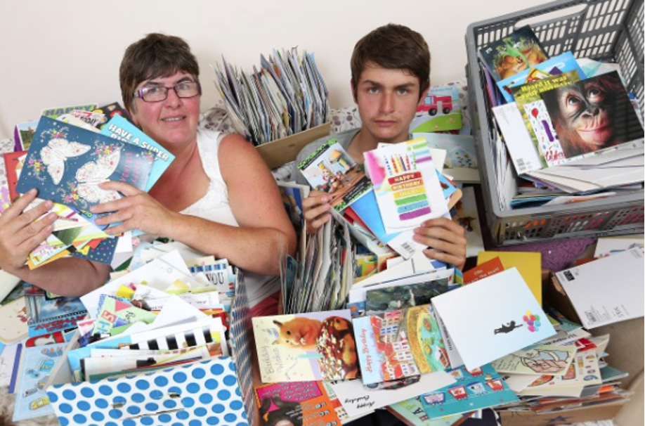 Ollie and his mother, Karen, surrounded by birthday cards sent from kind strangers